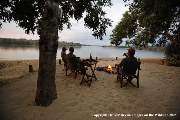 Hunters sitting around fire