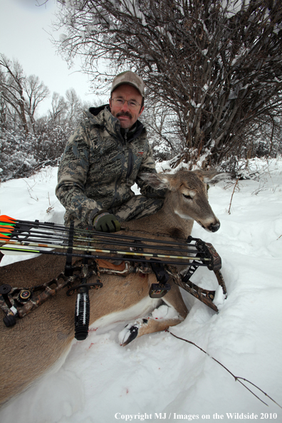 Archery hunter with bagged white-tailed doe. 