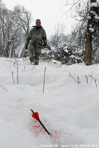 Archery hunter with passed-through arrow.