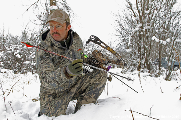 Archery hunter with passed-through arrow. 