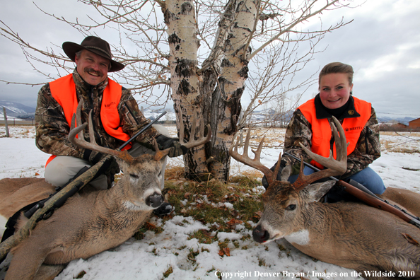 Hunters with downed bucks.  