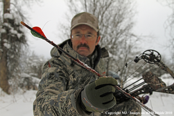 Archery huner with passed-through arrow. 