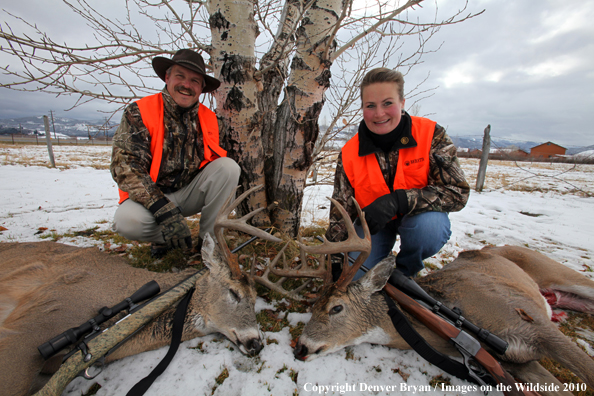 Hunters with downed bucks.  