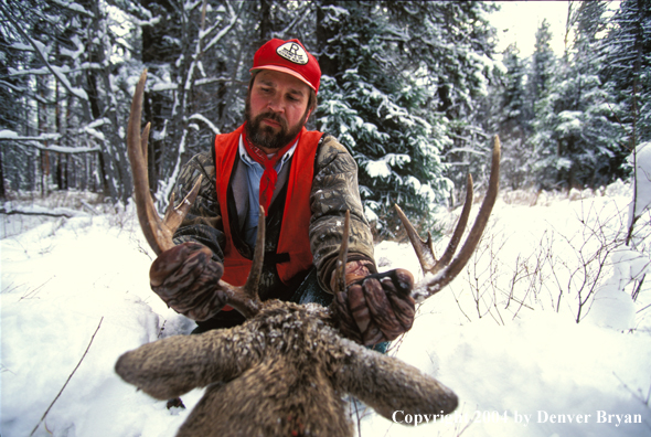 Hunter with bagged white-tailed deer.