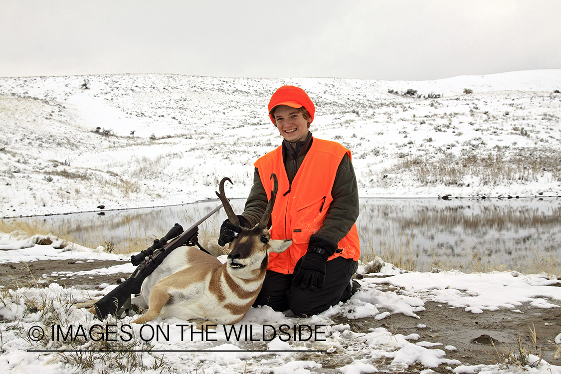 Young hunter with bagged pronghorn antelope. 