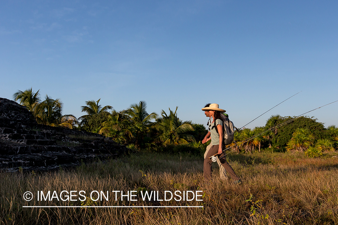 Flyfishermen hiking to water.