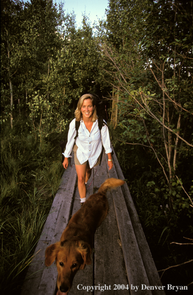Woman hiking with golden Retriever