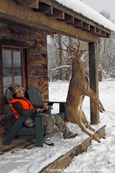 Hunter with bagged buck. 