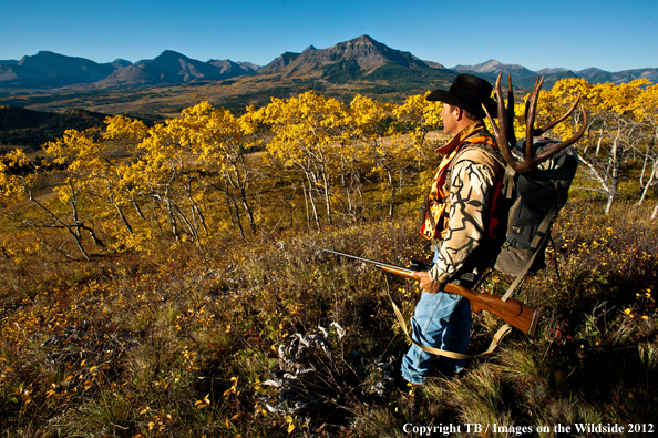 Big game hunter packing out mule deer. 