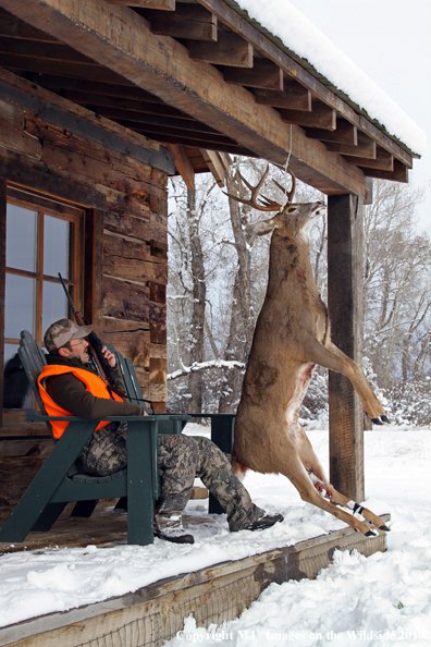 Hunter with bagged buck. 