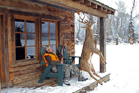 Hunter with bagged buck. 