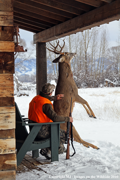 Hunter with bagged buck. 