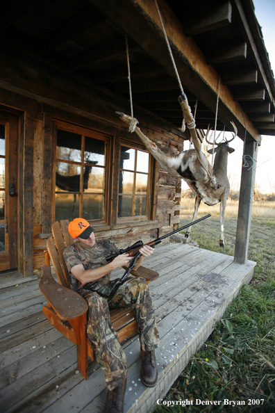 Hunter on porch of cabin