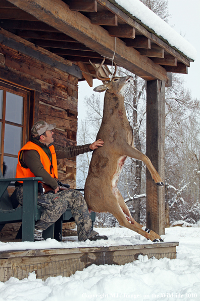 Hunter with bagged buck. 