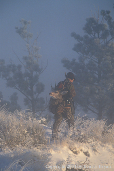 Big game hunter packing out kill.